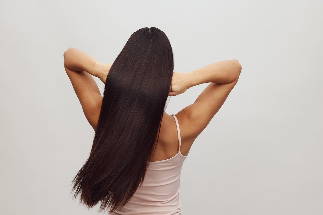 about-us-02 Asian woman with long, straight hair shown from behind, embracing hair care and beauty.