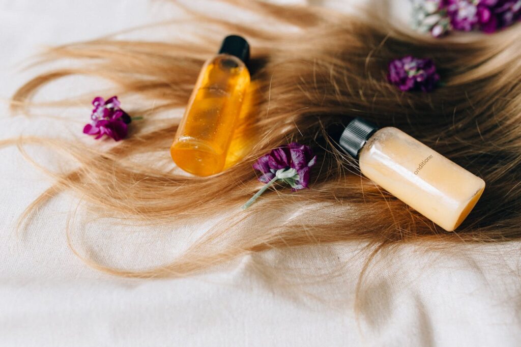 pexels photo 8467963 Hair care products on a bed of hair and flowers, symbolizing luxury and beauty.
